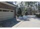 Long driveway leading to a garage with mature trees at 515 S Woodland Rd, Henderson, NC 27536