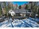 Picturesque single-Gathering home featuring brick accents, a manicured front yard, and a blanket of fresh snow at 515 S Woodland Rd, Henderson, NC 27536