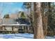 Well maintained brick home featuring green bushes and mature trees with a dark shingled roof at 515 S Woodland Rd, Henderson, NC 27536