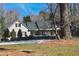 Beautiful single Gathering home with shutters, green grass, mature trees, and tasteful landscaping at 515 S Woodland Rd, Henderson, NC 27536
