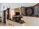 Game room wet bar featuring a dart board and partial view of the kitchen at 515 S Woodland Rd, Henderson, NC 27536