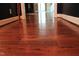 Hallway featuring beautiful hardwood flooring, base trim and natural light throughout at 515 S Woodland Rd, Henderson, NC 27536