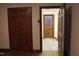 Interior showcasing a wooden door, tile flooring, and an entryway to another room at 515 S Woodland Rd, Henderson, NC 27536