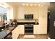 Well-equipped kitchen with stainless steel appliances, white cabinets, and granite countertops at 515 S Woodland Rd, Henderson, NC 27536