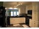 Modern kitchen with white cabinetry, stainless steel appliances and a pass-through to dining area at 515 S Woodland Rd, Henderson, NC 27536