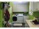 Bright laundry room with washer, dryer, storage and shelves at 515 S Woodland Rd, Henderson, NC 27536