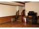 View of the living room featuring stairs, wood flooring, and a desk at 515 S Woodland Rd, Henderson, NC 27536