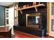 Living room features a dark brick fireplace with decorative mantel and hardwood floors at 515 S Woodland Rd, Henderson, NC 27536