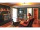 A living room with wood floors, a brick fireplace, an area rug, and views into other rooms at 515 S Woodland Rd, Henderson, NC 27536