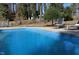 Beautiful in-ground pool with lounge chairs and a serene backyard setting at 515 S Woodland Rd, Henderson, NC 27536