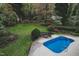 Inviting backyard with a sparkling in-ground swimming pool and comfortable lounge chairs at 515 S Woodland Rd, Henderson, NC 27536