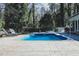 Inviting in-ground pool area with stone surround and landscaping at 515 S Woodland Rd, Henderson, NC 27536