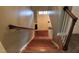 Staircase featuring carpeted and wood stairs with wooden railing in a well-lit hallway at 515 S Woodland Rd, Henderson, NC 27536