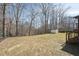 Landscaped backyard with mature trees and a well-manicured lawn, perfect for outdoor activities and relaxation at 5704 Whippoorwill St, Durham, NC 27704