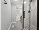 Bathroom showcasing a frameless glass shower, gray tiling, and modern fixtures creating a serene spa-like experience at 5704 Whippoorwill St, Durham, NC 27704
