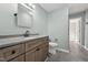 Bathroom featuring a dark wood vanity, gray countertop, tile floors, and modern fixtures at 5704 Whippoorwill St, Durham, NC 27704