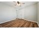 Neutral bedroom featuring wood-look floors, ceiling fan, and closet doors at 5704 Whippoorwill St, Durham, NC 27704