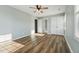 Neutrally painted bedroom featuring wood-look floors, closet and ensuite bathroom at 5704 Whippoorwill St, Durham, NC 27704