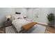 Sunlit bedroom with a plush bed, stylish bench, and soothing ambiance for ultimate relaxation at 5704 Whippoorwill St, Durham, NC 27704