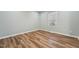 Bright bedroom featuring vinyl floors, a large window, and neutral decor, awaiting personal touches at 5704 Whippoorwill St, Durham, NC 27704