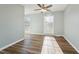 Bedroom features hardwood floors, neutral paint, and natural light from two windows at 5704 Whippoorwill St, Durham, NC 27704
