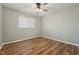 Bright bedroom featuring vinyl floors, a large window, and neutral decor, awaiting personal touches at 5704 Whippoorwill St, Durham, NC 27704