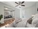 Bright bedroom with ceiling fan, light walls, and ensuite sitting room offers a relaxing retreat at 5704 Whippoorwill St, Durham, NC 27704