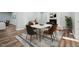 Well-lit dining area with modern furniture and a stylish area rug near the fireplace at 5704 Whippoorwill St, Durham, NC 27704