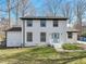 Charming two-story home featuring a classic white brick exterior and a light blue front door at 5704 Whippoorwill St, Durham, NC 27704