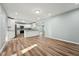 Open-concept kitchen showcasing white cabinetry, granite countertops, and stainless steel appliances at 5704 Whippoorwill St, Durham, NC 27704