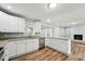 Modern kitchen with white cabinets, granite counters, stainless appliances, and an open layout at 5704 Whippoorwill St, Durham, NC 27704