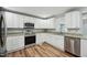 Well-appointed kitchen featuring stainless steel appliances, granite counters, and ample cabinet space at 5704 Whippoorwill St, Durham, NC 27704