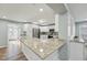 Open concept kitchen with stainless steel appliances, granite countertops, and breakfast bar at 5704 Whippoorwill St, Durham, NC 27704