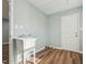 Bright laundry room with utility sink, new floors, and fresh paint at 5704 Whippoorwill St, Durham, NC 27704