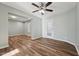 A cozy living room featuring hardwood floors, a ceiling fan, and serene light-colored walls at 5704 Whippoorwill St, Durham, NC 27704