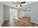 Spacious living room with hardwood flooring, ceiling fan, and a bright, airy atmosphere at 5704 Whippoorwill St, Durham, NC 27704