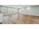 Spacious living room with hardwood floors, natural light, and a ceiling fan at 5704 Whippoorwill St, Durham, NC 27704