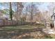 Large backyard featuring grass, trees, and a wooden fence at 5900 Damon Ct, Raleigh, NC 27610