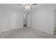 Spacious bedroom featuring neutral carpet, a ceiling fan, and doors to the hallway and bathroom at 5900 Damon Ct, Raleigh, NC 27610