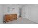 Bedroom features neutral carpet, a wood dresser, and ample closet space at 5900 Damon Ct, Raleigh, NC 27610