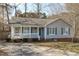 Charming single-story home with a welcoming front porch and classic blue shutters at 5900 Damon Ct, Raleigh, NC 27610