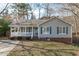 Well-maintained home featuring a cozy front porch and neat landscaping at 5900 Damon Ct, Raleigh, NC 27610