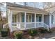 Inviting front porch with white railings and brick base, perfect for relaxing outdoors at 5900 Damon Ct, Raleigh, NC 27610