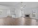 Bright living room with a fireplace, wood-look flooring, and a ceiling fan at 5900 Damon Ct, Raleigh, NC 27610