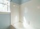 Light and airy bathroom featuring white tiled shower and tub with adjacent window at 5917 Sentinel Dr, Raleigh, NC 27609