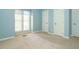 Light-filled bedroom with neutral carpeting, white trim, and two large closets is displayed at 5917 Sentinel Dr, Raleigh, NC 27609