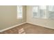 Neutral carpeted bedroom with a large window and white trim at 5917 Sentinel Dr, Raleigh, NC 27609