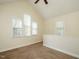 Bright bedroom featuring neutral paint, carpet, and an angled ceiling with a ceiling fan and windows at 5917 Sentinel Dr, Raleigh, NC 27609