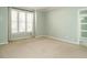Spacious bedroom featuring neutral walls, plush carpeting, and bright windows at 5917 Sentinel Dr, Raleigh, NC 27609