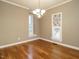 Dining room featuring hardwood floors, neutral walls, and a decorative chandelier at 5917 Sentinel Dr, Raleigh, NC 27609
